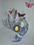 Silver tone with a yellow stone