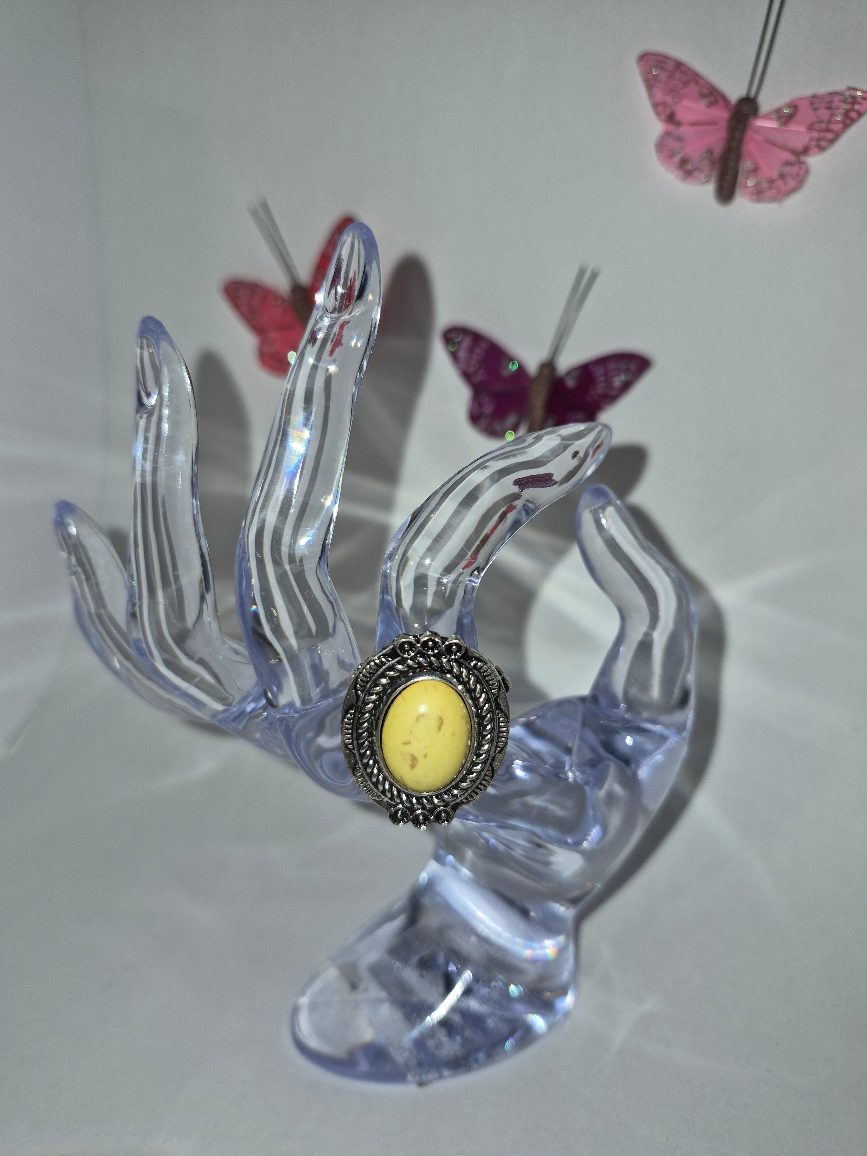 Silver tone with a yellow stone